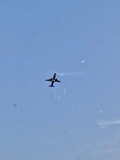 an airplane is flying in the sky on a clear day with no one around it