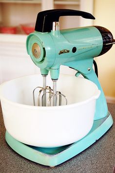 an electric mixer sitting on top of a counter