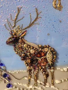 a close up of a deer made out of beads and other items on a table