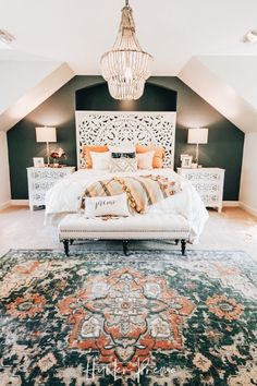 a bedroom with a bed, rug and chandelier hanging from the ceiling above it