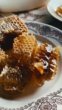 some honeycombs are on a white plate with black and white designs around them