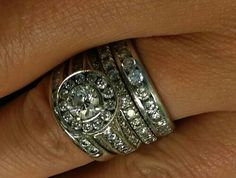 a woman's wedding ring is shown on her finger, with two diamonds in the middle