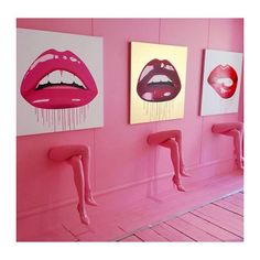 three paintings hanging on the wall in a room with pink walls and wooden flooring