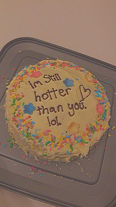 a birthday cake with icing and sprinkles on it that says, i am not hotter than you lol