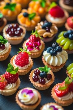 there are many small cupcakes with fruit on them