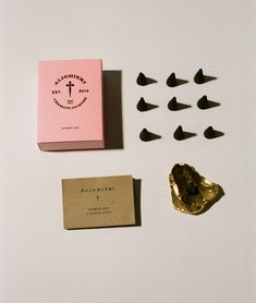 some chocolates are sitting on a table next to a card and other things that include them