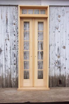 a wooden door sitting on the side of a building