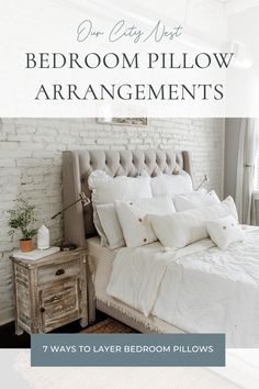 a bedroom with white bedding and pillows