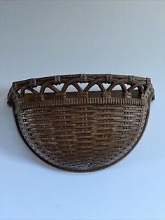 an old wicker basket hanging on the wall