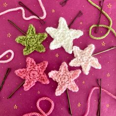 several crocheted stars are arranged on a pink surface