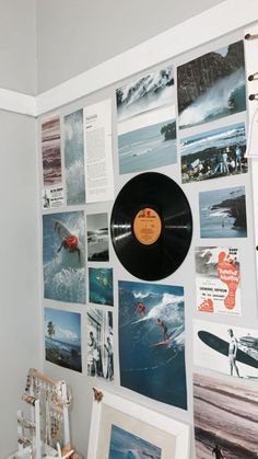 there is a wall with pictures on it and a record in front of the photo