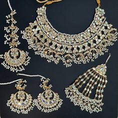 An absolute showstopper necklace with high quality mirror work and a modern luxurious look for any jewelry lover! This necklace comes with matching earrings, tikka, passa, jhoomar that are perfect to wear alone for a lighter look. High Quality Silver, gold and glass finish with beaded work, this set is sure to be a perfect addition to any wardrobe! This semi bridal but lightweight and elegant necklace is perfect for any bridesmaid, bride, sangeet or any occasion or event as a gift for any occasi Luxury Peacock Design Bridal Necklace For Festive Occasions, Luxury Traditional Bridal Necklace With Peacock Design, Luxury Meenakari Sets For Reception, Luxury Mirror Work Jewelry For Diwali, Luxury Wedding Tikka, Luxury Elegant Tikka As Gift, Luxury Stone Work Tikka For Reception, Luxury Hand Set Silver Tikka, Punjabi Clothes