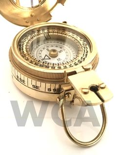 an old brass compass is being used as a keychain to find the direction