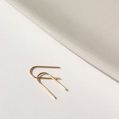 Simple and effortless, yet anything but basic, our 14k gold Arches minimal design means endless wear for everyday style. A great earring for sensitive ears and a must-have addition to your fine jewelry collection. DETAILS14k Solid GoldApprox. 0.5" dropHypoallergenic, Nickel Free and Water Safe Simple Design 14k Gold Earrings, Tiny Modern Gold Earrings, Modern Tiny Earrings For Gift, Tiny Modern Earrings For Gift, Minimalist Hypoallergenic Earrings In Recycled Gold, Minimalist Hypoallergenic Recycled Gold Earrings, Classic Everyday Hoop Earrings In Recycled Gold, Tiny Classic Gold Earrings, Minimalist 14k Gold Jewelry For Everyday