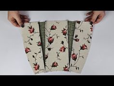 three pieces of fabric with flowers on them are being held by two hands over a white surface