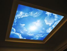 the sky is bright and blue with clouds in it, as well as a ceiling light