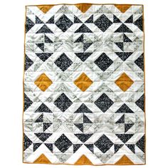 a black and white quilt with an orange border