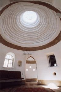 the inside of a building with a circular ceiling and arched doorways, in front of a window