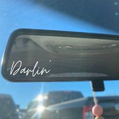 the rear view mirror of a car with writing on it