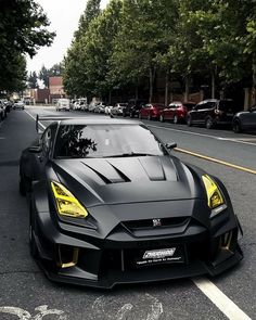 a black sports car is parked on the street