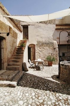 an outdoor patio area with stone steps and potted plants