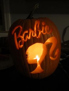 a carved pumpkin with the word barbie on it