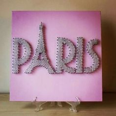 a pink greeting card with the word dad spelled out in silver beads on it's sides