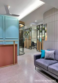 an office lobby with blue and grey furniture