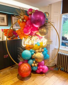 a party decoration with balloons and streamers