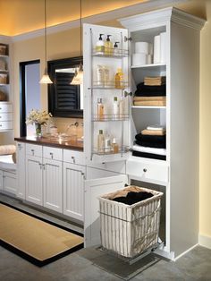 a white cabinet with shelves and baskets in it