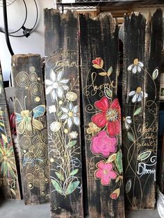 several wooden boards with flowers painted on them