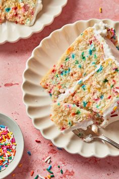 a slice of cake on a plate with sprinkles and a fork next to it