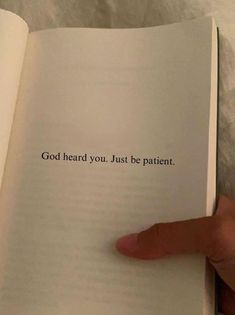 someone is holding an open book with the words god heard you just be patient