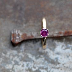 this sweet ring, forged from 14k gold, features a native cut ruby in a tapered bezel setting that interrupts the smooth high polished band; a simple yet lovely petite sparkly statement. Ring is size 4.5, and I do have other likely rubies if you would like a ring made just for you in your size. DETAILS: Ruby, 4.5mm and .4 ct ring is solid 14k yellow gold band is 2.5mm x 1.7mm weight of ring is over 1 1/2 pennyweights size 4.5 *this ring is in stock and ready to ship in a size 4.5, if you would li Sweet Ring, July Birthstone, 14k Gold Ring, Multi Stone Ring, Ruby Ring, Gold Band, Bezel Setting, Gold Bands, Statement Ring