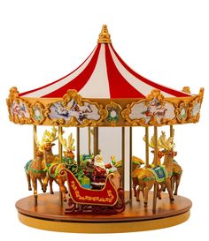 a merry go round carousel with christmas decorations on it's sides and the words, the merries light up christmas carousel