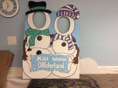 two snowmen wearing hats and scarves are standing in front of a sign that says miss winter oldenland