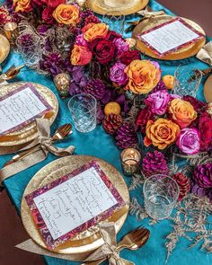 the table is set with place cards and goldware for guests to write their names