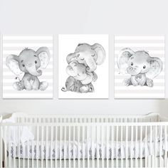 two pictures of elephants are hanging on the wall next to a crib in a baby's room