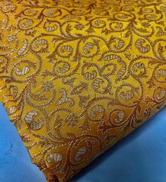 "This one yard listing is for a sunset yellow sari brocade fabric by the yard with a beautifully contrasting woven in a regal pattern. For a yard, you will get 36\" X 44\" or @ 90cm X 110cm. ABOUT BROCADES These brocades are machine woven.  A metallic thread that is golden/ bronze/ silver/ copper in color is cross woven in a pre-set pattern with the base thread usually of a bright color.  They are manufactured in Benares or Banaras, which is one of the biggest fabric hubs of North India and is k Yellow Sari, Sunset Yellow, Wedding Ring Cushion, Royal Indian, Theatre Costumes, North India, Cushion Ring, Lined Curtains, Set Patterns