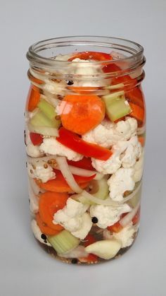 a glass jar filled with lots of veggies