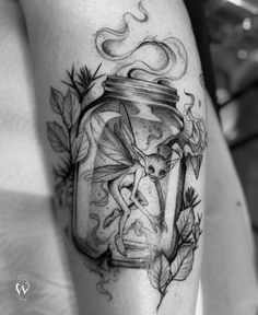 a black and white photo of a jar with a fairy on it