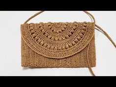 a crocheted purse is shown on a white surface