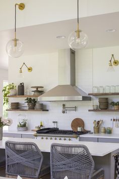 the kitchen is clean and ready to be used for cooking or dining, with wicker chairs around the island