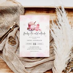 a baby it's cold outside party is set up on a table with feathers, scissors and other items