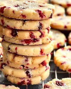 a stack of cookies with cranberry toppings on a cooling rack, ready to be eaten