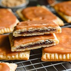 several pastries on a cooling rack with peanut butter and jelly fillings in the background