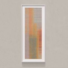 an abstract painting hangs on the wall in front of a white framed art print with orange and yellow stripes