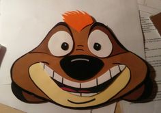 a paper cut out of the face of an angry dog with orange hair and eyes