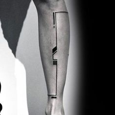 a black and white photo of a person's leg with a tattoo on it