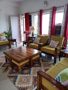 a living room filled with furniture and red curtains